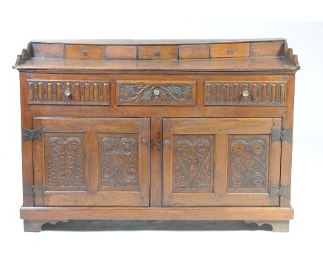 An 18th Century oak dresser sideboardHaving three spice drawers above a rectangular plank top with rounded front corners over