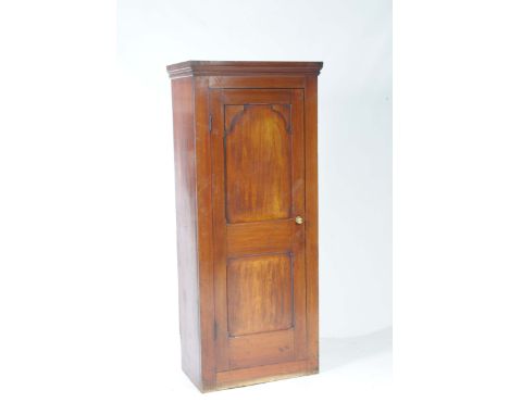 A late 19th early 20th Century mahogany hall cupboardWith a moulded cornice above a single panelled door enclosing a single s