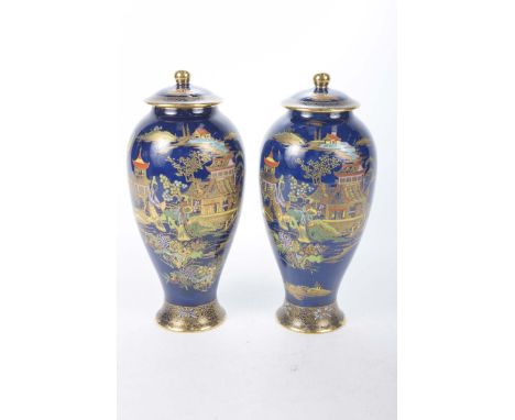 A pair of Carltonware vases and covers, early 20th centuryThe vases with blue colourway decorated with oriental scenes, heigh