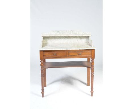 An Edwardian oak marble top wash standThe marble galleried top with a single rear shelf above two frieze drawers and raised u