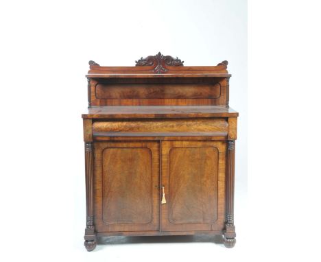 A fine William IV mahogany chiffonierThe architectural raised back with a central scrolling crest above a single shelf suppor