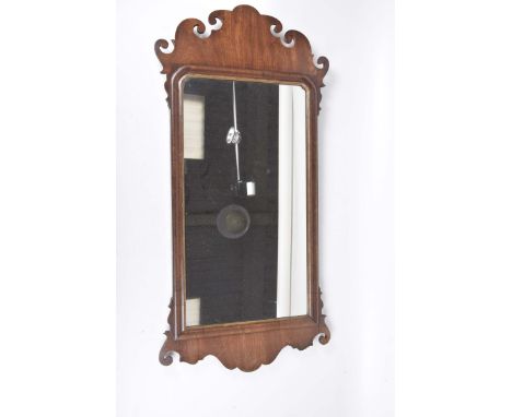 A Chippendale-style mahogany framed wall mirror, 19th centuryThe 60 x 32cm mirror with pierced crest and base.