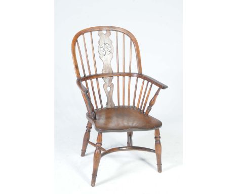 An 18th / 19th Century elm and yew Windsor farmhouse elbow chairThe arched stick back with a central shaped splat pierced wit