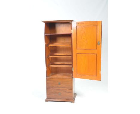 An early 20th Century mahogany hall cupboardWith a single door enclosing a shelf and racks, above two drawers raised on compr