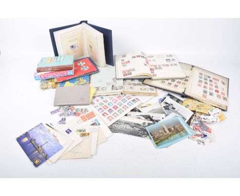 A large collection of stamp albumsTo include loose stamps, commemorative first day editions, world stamps, stamp reference bo