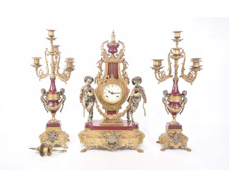 A substantial Italian made clock garniture, mid to late 20th CenturyThe 61cm high clock with elaborate gilt decoration and tw