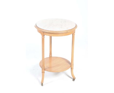 An early 20th Century marble top occasional tableThe circular top with an inset white marble slab supported on three fluted a