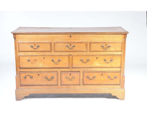 A George III oak and mahogany crossbanded Lancashire mule chestWith a rectangular hinged top above three faux drawers, a long