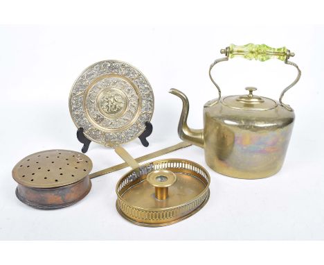 Four brass items To include a brass kettle with coloured glass overhead handle, brass chestnut roaster, a brass chamber stick