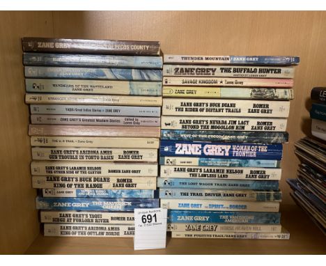 A collection of approximately 32 vintage Zane Grey Western paperbacks