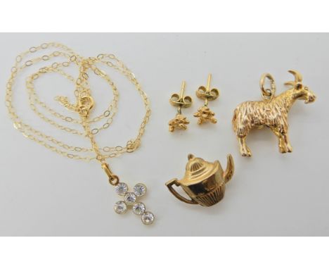 A 9ct gold goat charm, a teapot, teddy earrings and a gem set cross pendant  Condition Report: 