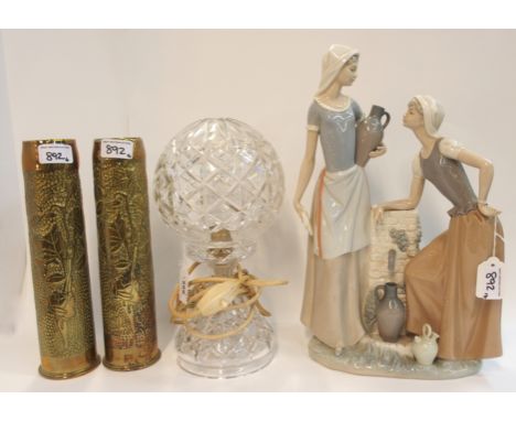 A pair of brass shell cases vases, a crystal table lamp and a Nao group of two girls by a fountain (4)  Condition Report: 