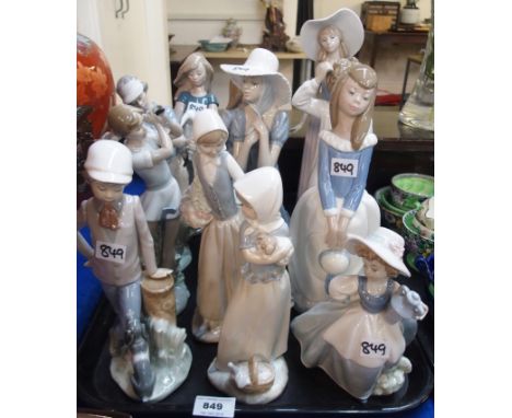 Twelve Nao figures including girl with rabbit, golfers etc  Condition Report: 