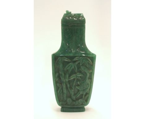 A Chinese green hardstone bottle and cover, carved to each side with a bird and foliage, 15cm high (def to finial on lid)  Co