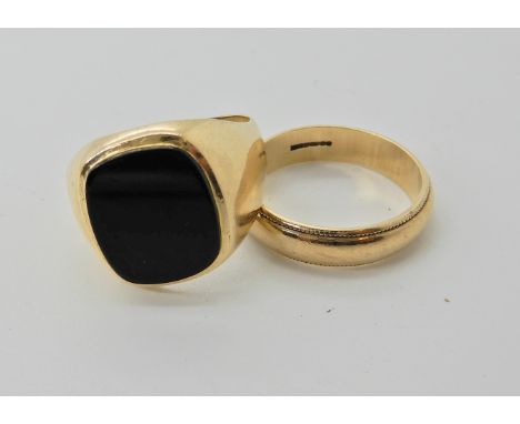 A 9ct onyx signet ring finger size T1/2, together with a 9ct wedding ring finger size R  Condition Report: 