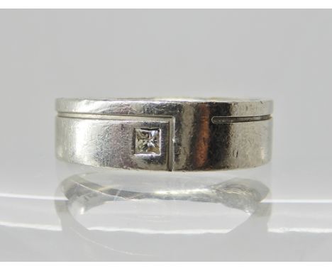 A platinum and diamond wedding band with an unusual finger print design to the interior also inscribed. Finger size Q1/2, wei