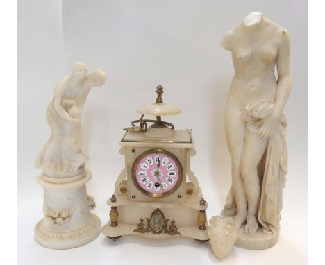 An alabaster mantel clock with pink dial, 30cm high, an alabaster figure group of a mother and child, 34cm high and another f