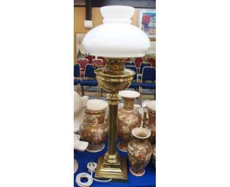 A brass Corinthian column paraffin lamp, with white glass shade, 78cm high (converted for electricity)  Condition Report: 