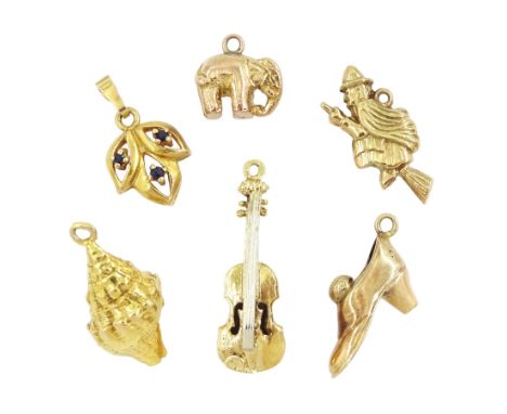 14ct violin charm and shoe, 10ct shell charm, 9ct elephant, witch and sapphire pendantCondition Report:14ct approx 3.7gm, 10c
