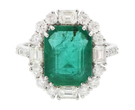 18ct white gold octagonal cut emerald, round brilliant cut and baguette cut diamond cluster ring, with diamond set shoulders,