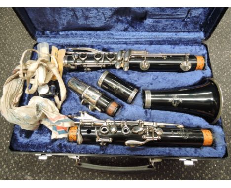 A Buffet Crampon Clarinet, in hard case, with books etc