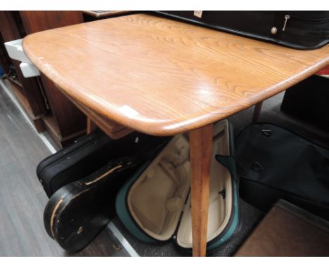 A mid/late 20th century light Ercol dining/kitchen table having elm top on splay legs