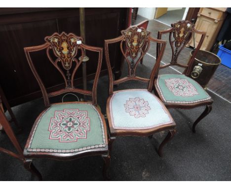Three late Victorian mahogany salon chair having ornate inlay decoration with tapestry seats and slender legs 