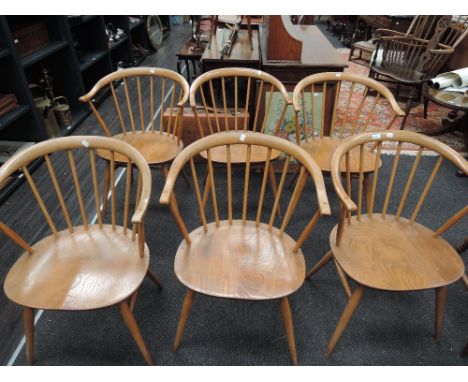 A set of six light Ercol spindle back kitchen armchairs having solid elm seats