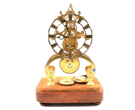 Victorian brass skeleton clock, pierced chapter ring, single fusee movement, mahogany platform, lacking dome, 30cm. 
