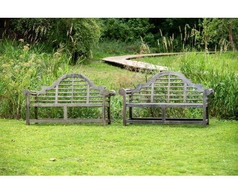 A PAIR OF HARDWOOD GARDEN BENCHES  IN THE MANNER OF EDWIN LUTYENS, CONTEMPORARY  Slight size variance, each approximately 100