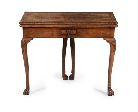 AN IRISH GEORGE II WALNUT FOLDING CARD TABLE CIRCA 1740 Incorporating ash feather banding to the top, distinctive twin gatele