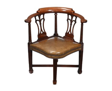 A GEORGE III MAHOGANY CORNER ARMCHAIR  CIRCA 1780 With fluted and stop-flued decoration to the supports  81cm high   Provenan