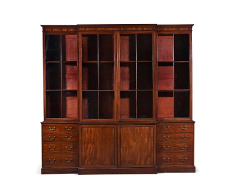 A GEORGE III MAHOGANY BREAKFRONT LIBRARY BOOKCASE CIRCA 1770 The central cabinet doors opening to a shelved interior 273cm hi