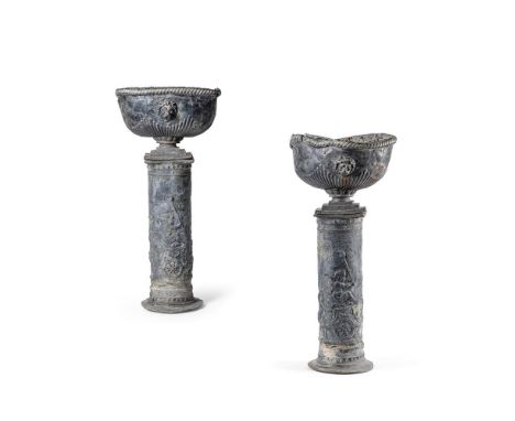A PAIR OF LEAD PLANTERS ON STANDS  EARLY 19TH CENTURY  Each with lion mask mounted gadrooned planter on cylindrical stem with