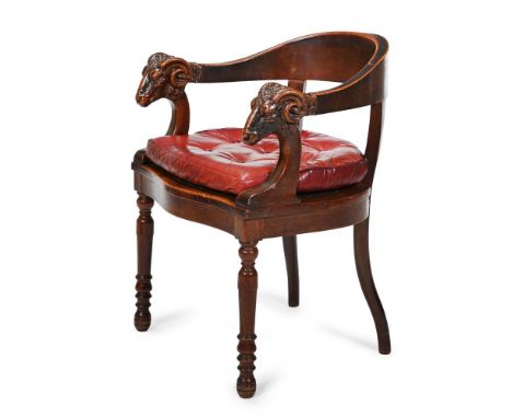 A VICTORIAN CARVED OAK DESK ARMCHAIR  MID 19TH CENTURY The arms carved with ram's heads, with loose buttoned leather squab se