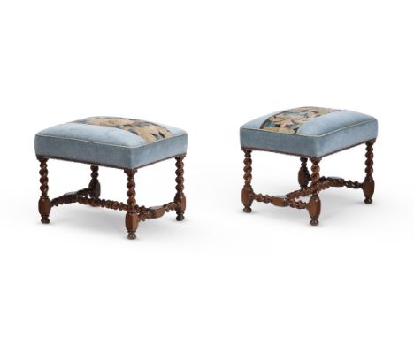 A PAIR OF WILLIAM III WALNUT STOOLS CIRCA 1700 Upholstered in 17th century style needlework each 43cm high, 52cm wide, 41cm d