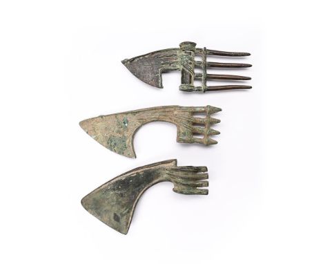 THREE LURISTAN BRONZE SHAFT-HOLE AXE-HEADS  NORTH WEST IRAN, CIRCA 10TH-8TH CENTURY B.C.  largest 22cm long  Provenance: Prop