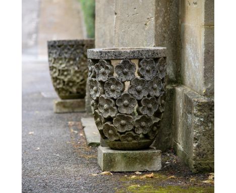 A PAIR OF PIERCED AND CARVED STONE PLANTERS 20TH CENTURY The sides carved with flowerheads  each 60cm high, 40cm diameter  Co