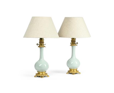 A PAIR OF FRENCH GILT BRONZE MOUNTED PORCELAIN TABLE LAMPS WITH SHADES  LATE 19TH CENTURY AND LATER  Pale Celadon green glaze