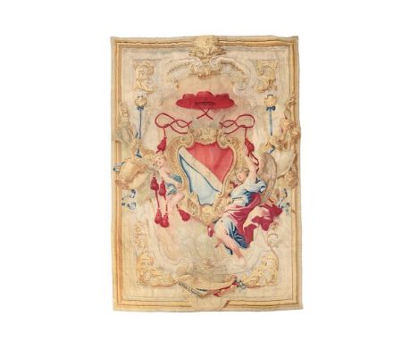 AN ITALIAN ARMORIAL TAPESTRY  18TH CENTURY  Woven with a cardinal's hat and ribbons above a central coat of arms, enclosed wi