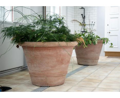 A PAIR OF OVERSIZED TERRACOTTA POTS  MODERN  Twin rib decoration to tapering cylindrical bodies  approximately 79cm high, top