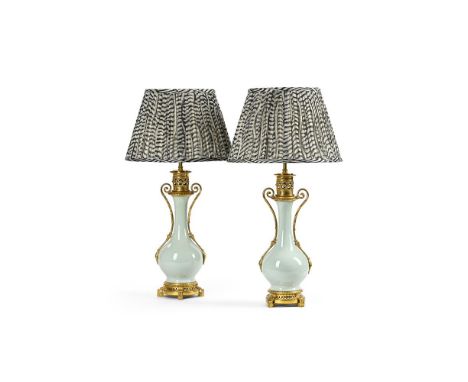 A PAIR OF FRENCH GILT BRONZE MOUNTED PORCELAIN TABLE LAMPS WITH SHADES  LATE 19TH CENTURY AND LATER  Pale Celadon green glaze