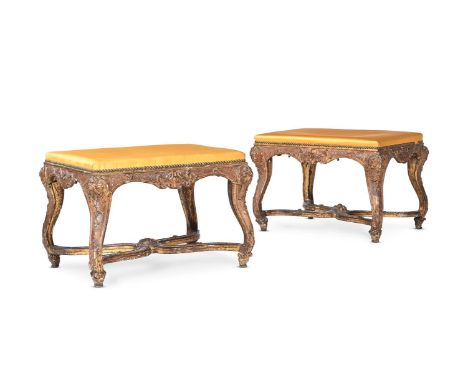 A PAIR OF RÉGENCE CARVED GILTWOOD STOOLS CIRCA 1720 52cm high, 64cm wide, 48cm deep  Provenance: Property of a Lady of Title 