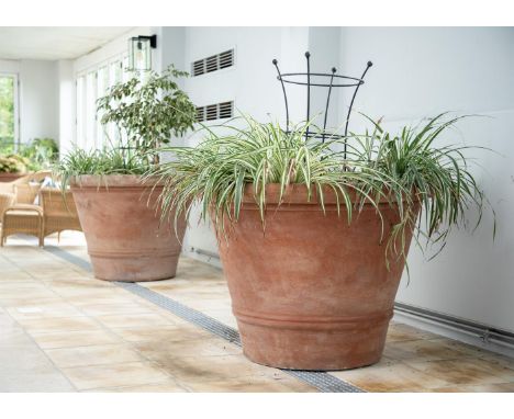 A PAIR OF OVERSIZED TERRACOTTA POTS  MODERN  Twin rib decoration to tapering cylindrical bodies  approximately 79cm high, top