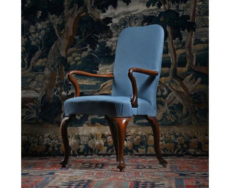 A GEORGE I WALNUT ARMCHAIR CIRCA 1720 The front legs incorporating C scroll carved detail, raised on brass 'roller' casters 1