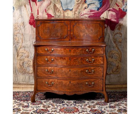 A GEORGE III FIGURED MAHOGANY SECRETAIRE SERPENTINE COMMODE ATTRIBUTED TO HENRY HILL OF MARLBOROUGH, CIRCA 1770 The upper sec