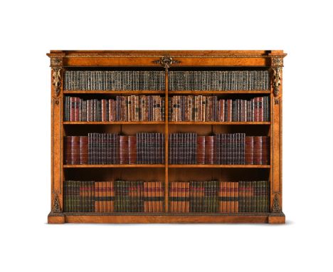 A WILLIAM IV POLLARD OAK AND GILT METAL MOUNTED OPEN BOOKCASE IN THE MANNER OF MOREL & SEDDON, CIRCA 1835 With adjustable she