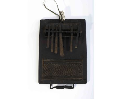 A kisanji, wood and iron lamellophone, carved decoration "Geometric motifs", Angolan - Tshokwe, 20th C. (1st quarter), missin