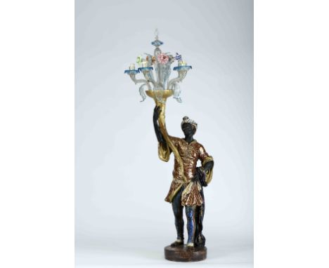 A «Blackamoor» five-light candle holder, faience sculpture, polychrome and gilt decoration, glass chandelier and colourless M