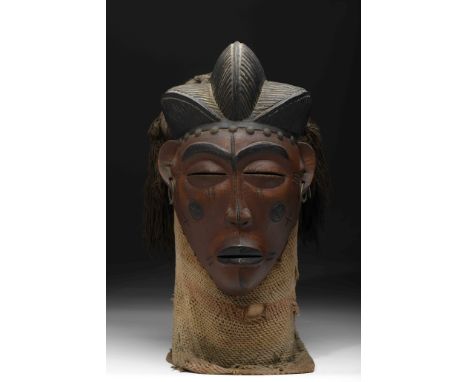 A «Mwana Pwo» Mask, wood, fibers and metal, It has metallic rings in both ears, a mask representing the ideal of female beaut